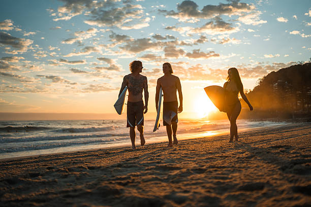 istock Caucasian Friends Joyfully Surfing at Sunrise 2236849454