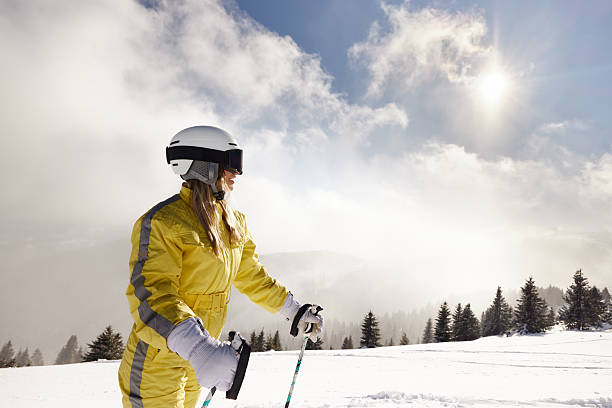 Carefree female skier during winter day on a mountain. Copy space.