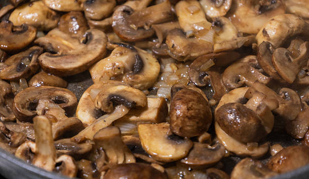 istock sliced mushrooms and onions sizzling in a hot pan 2236850626