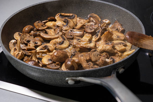 istock sliced mushrooms and onions sizzling in a hot pan 2236850628
