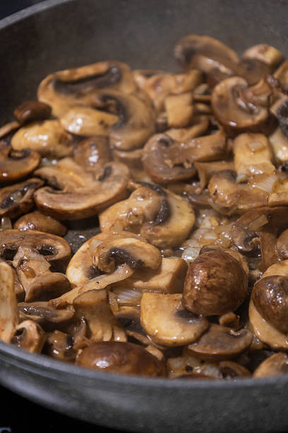 istock sliced mushrooms and onions sizzling in a hot pan 2236850629