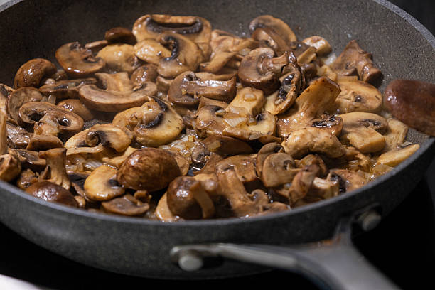 istock sliced mushrooms and onions sizzling in a hot pan 2236850633