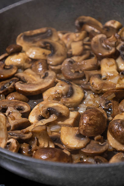istock sliced mushrooms and onions sizzling in a hot pan 2236850635