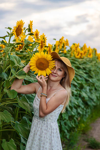 istock Woman in sunflowers in a field. Selective focus. 2236851204