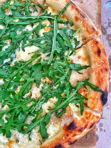 istock Fresh pizza with arugula, cheese and golden crust 2236851354