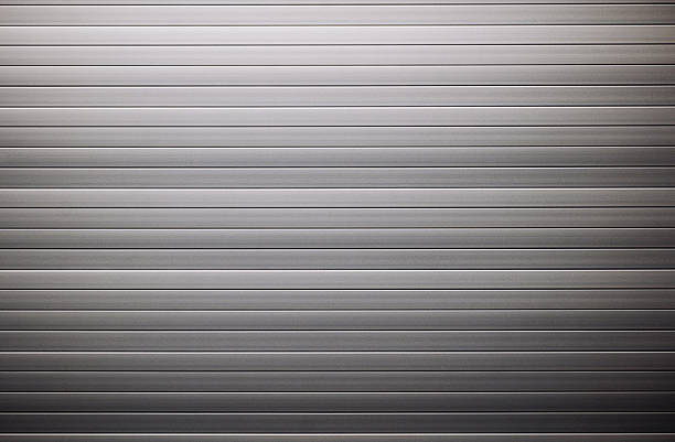 istock Corrugated metal sheet creating a striped metallic background 2236853163