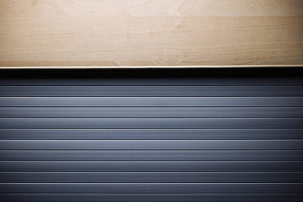 istock Light wooden shelf is casting a shadow on a dark gray slat wall 2236853237