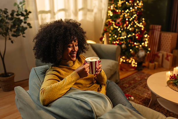 istock Young woman relaxing on sofa drinking hot chocolate during Christmas holidays 2236853765