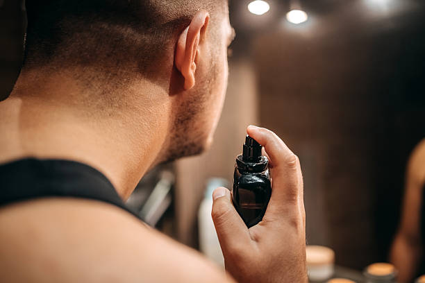 istock Young man at home standing in front of mirror in bathroom and doing morning routine 2236855647