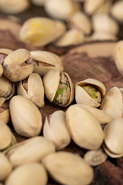 istock unpeeled pistachio nuts fried in salt, scattered pistachios after roasting with cracked shells 2236859517