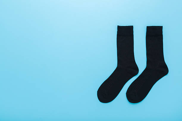 A stack of black socks isolated on a white background