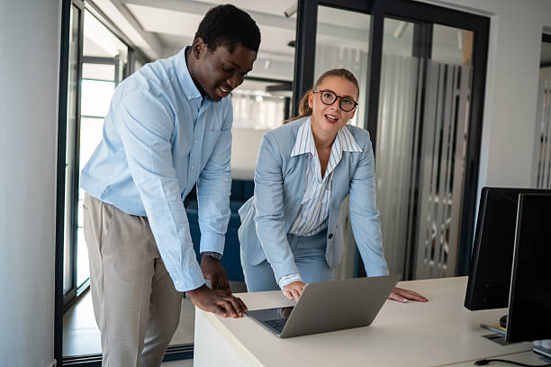 istock Business colleagues collaborating on laptop in modern office workspace 2236860504