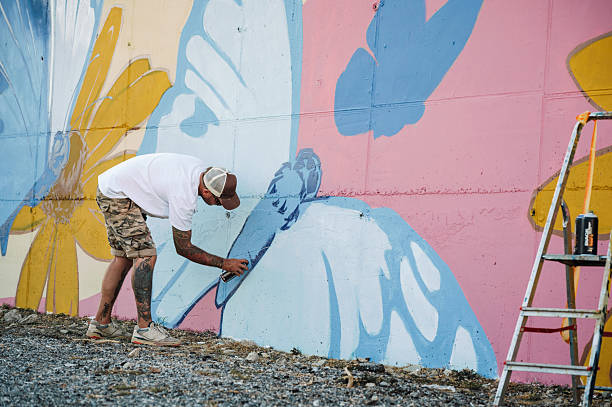istock Male artist working on a big wall painting / mural 2236861925