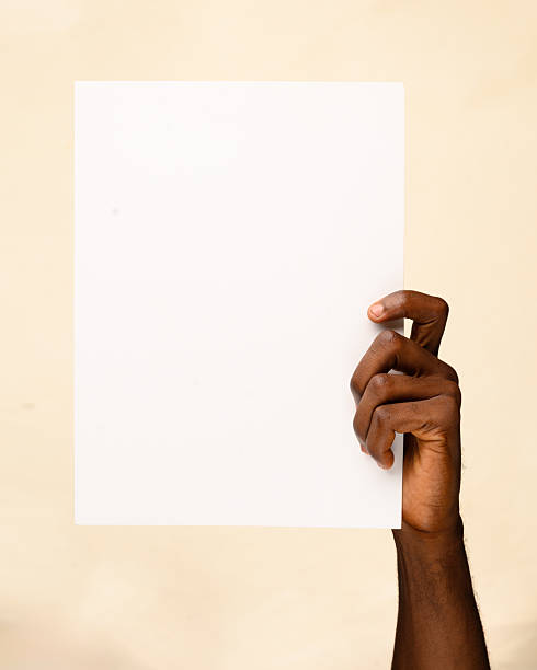 istock Hand holding blank white paper sheet against neutral background 2236862094