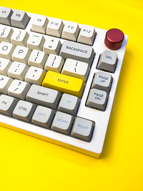 istock White mechanical keyboard with bright Enter key on bright yellow background, minimalism, keyboard buttons. A keyboard with a yellow key on the bottom left 2236865158