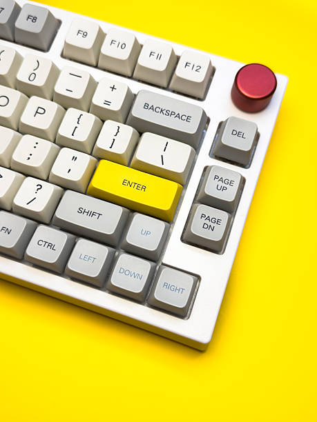istock White mechanical keyboard with bright Enter key on bright yellow background, minimalism, keyboard buttons. A keyboard with a yellow key on the bottom left 2236869333