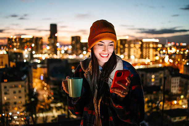 istock Woman enjoying hot drink on rooftop at night 2236870536