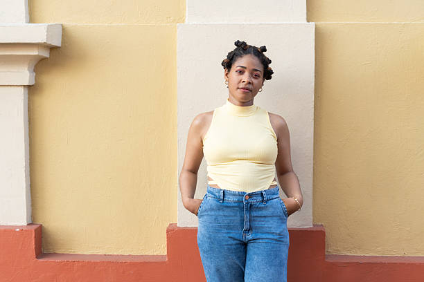 istock Young black woman with confident expression standing by wall 2236874359