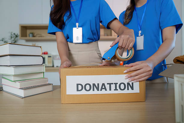 istock Donation Packaging. Volunteers preparing boxes for community donations. 2236874895