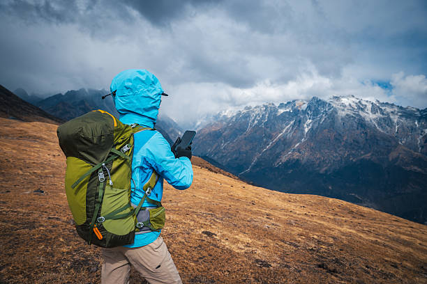 Backpacking woman hiking on high altitude mountain top