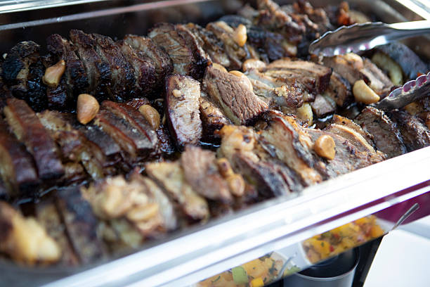 Barbecue ready and cut over metal tray on table for lunch