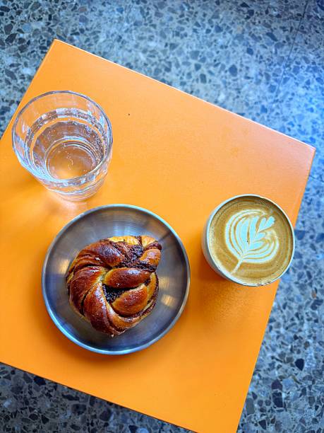 istock Hydration and caffeination with water coffee and a cinnamon bun for fuel 2236880617