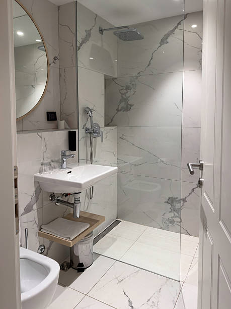 istock Modern minimalistic bathroom interior with marble tiles and glass shower cabin 2236881428