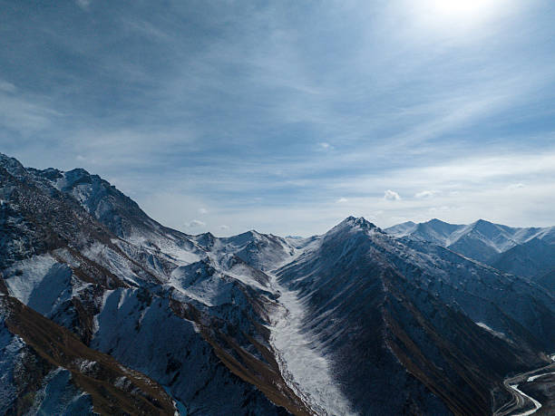istock Magnificent Scenery of Snow-Capped Mountains Under a Blue Sky 2236882605