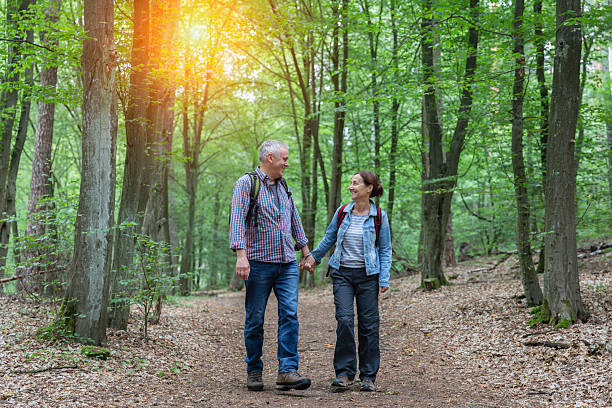 istock Hiking - senior couple walking through the forest 2236884994