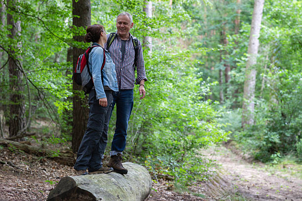 istock Hiking - senior couple walking through the forest 2236885014