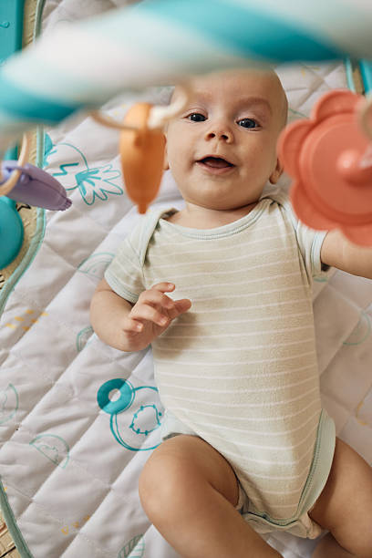 istock Smiling baby boy playing on activity play mat 2236885112