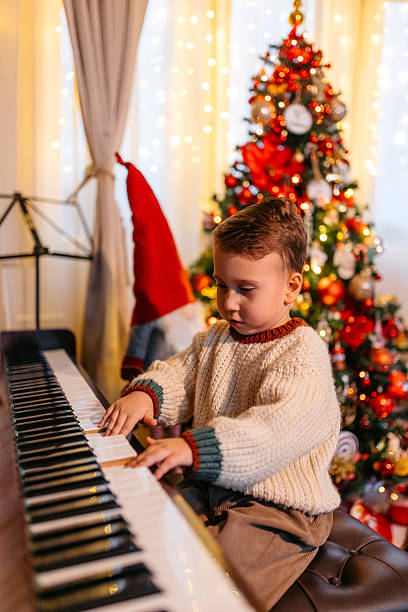 istock A Boy Playing The Piano During Christmas Holidays 2236885977