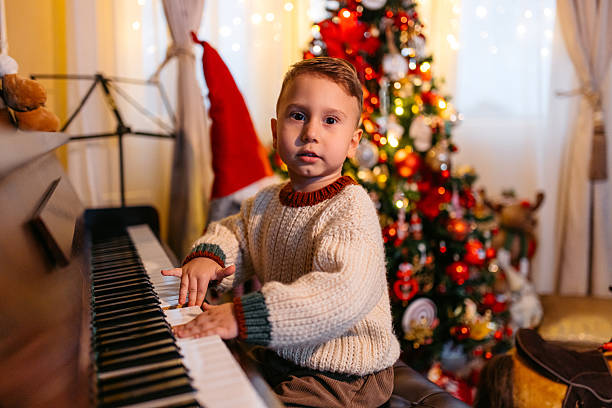 istock A Boy Playing The Piano During Christmas Holidays 2236886149