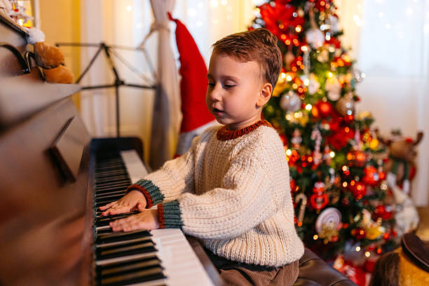 istock A Boy Playing The Piano During Christmas Holidays 2236886675