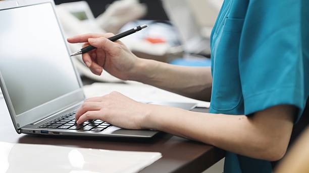 Hands of an Asian caregiver doing clerical work stock photo