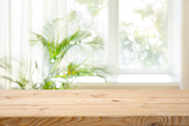 istock Empty wood table top on blurred curtained window and abstract greenery from garden background 2236889985