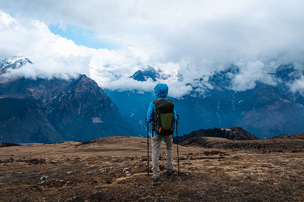 Backpacking woman hiking on high altitude mountain top