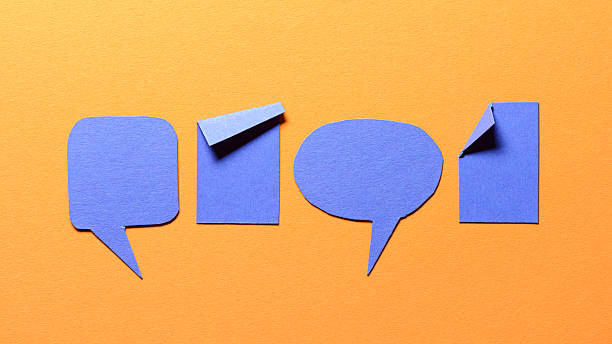istock Blue speech bubbles and paper memo notes with folded dog-ear earmark and copy space for text on orange background, communication dialog concept top view flat lay 2236893662