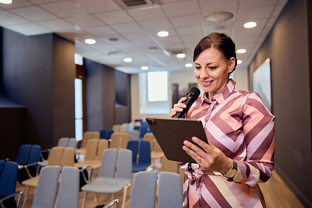 istock Professional Woman Preparing Presentation in Empty Conference Room With Microphone 2236893703