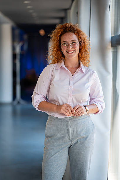 istock Confident young woman smiling indoors at workplace 2236894090