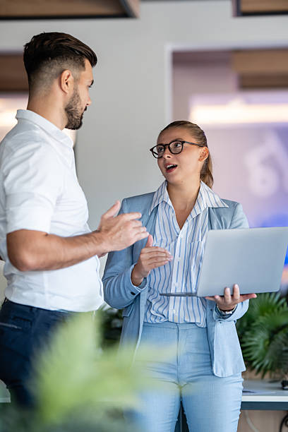 istock Business professionals discussing strategy with laptop in modern office setting 2236894311