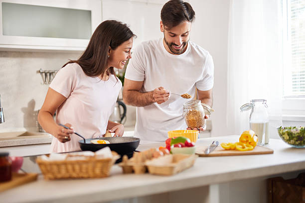 istock Happy couple preparing breakfast together in modern kitchen 2236895586