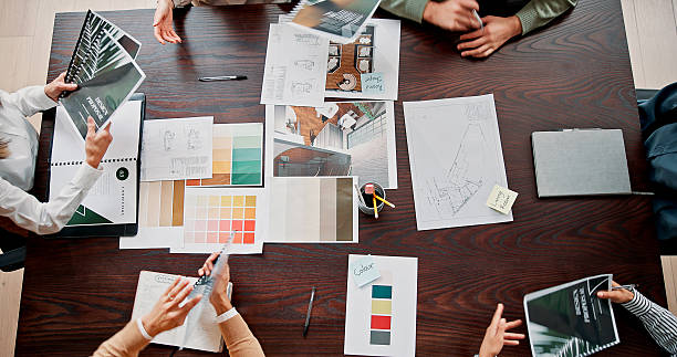 Interior design, teamwork and above of people in meeting for project ideas, research and discussion. Creative agency, office and workers with paperwork for planning, collaboration and color palette Interior design, teamwork and above of people in meeting for project ideas, research and discussion. Creative agency, office and workers with paperwork for planning, collaboration and color palette branding agency stock pictures, royalty-free photos & images