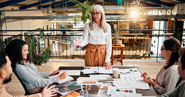 istock Presentation, manager and business people in office with documents for planning creative project. Feedback, meeting and team of magazine editors in discussion with paperwork review for publishing. 2236900507