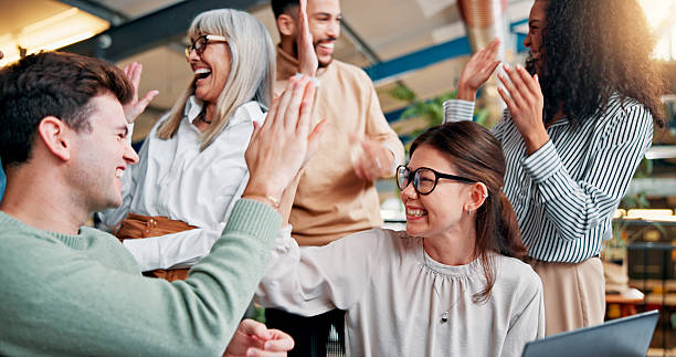 istock High five, success and business people with team for winning, bonus or creative proposal approval. Excited,  group and laptop with happiness, cheers and celebrate for collaboration funding at startup 2236900567