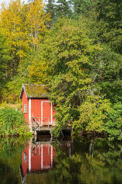istock Idyllic red bath cottage by a lake 2236902658