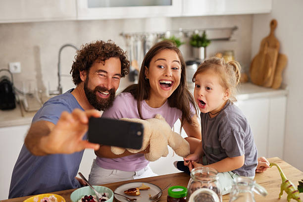 istock Family taking selfie together in kitchen at breakfast 2236903402