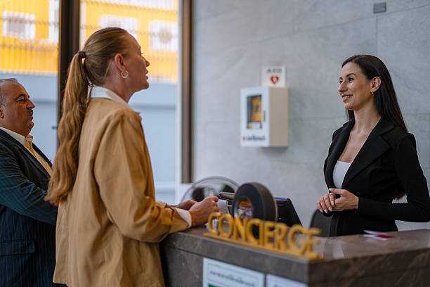 istock A receptionist is working with customers at the hotel's counter. 2236903881