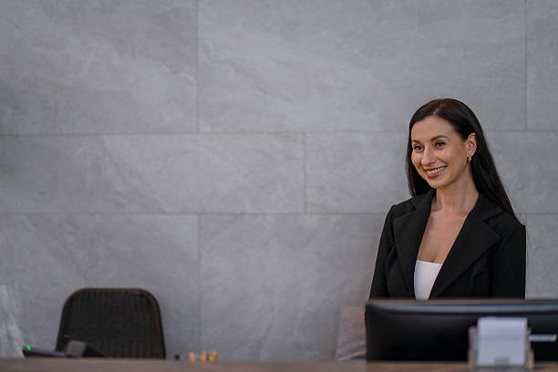 istock A receptionist is working at the hotel's counter. 2236903926