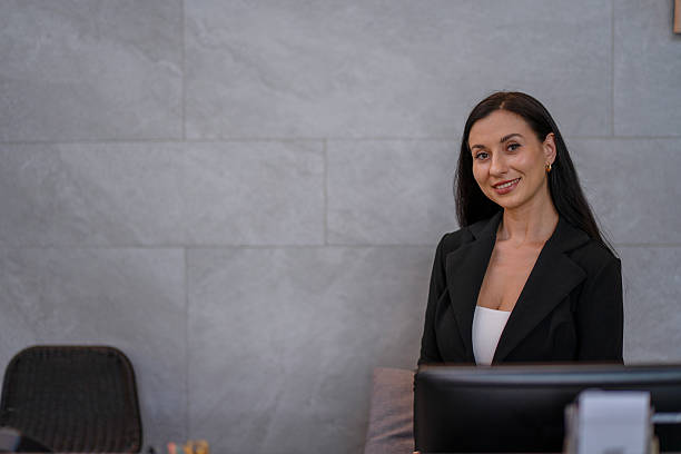 istock A receptionist is working at the hotel's counter. 2236903941